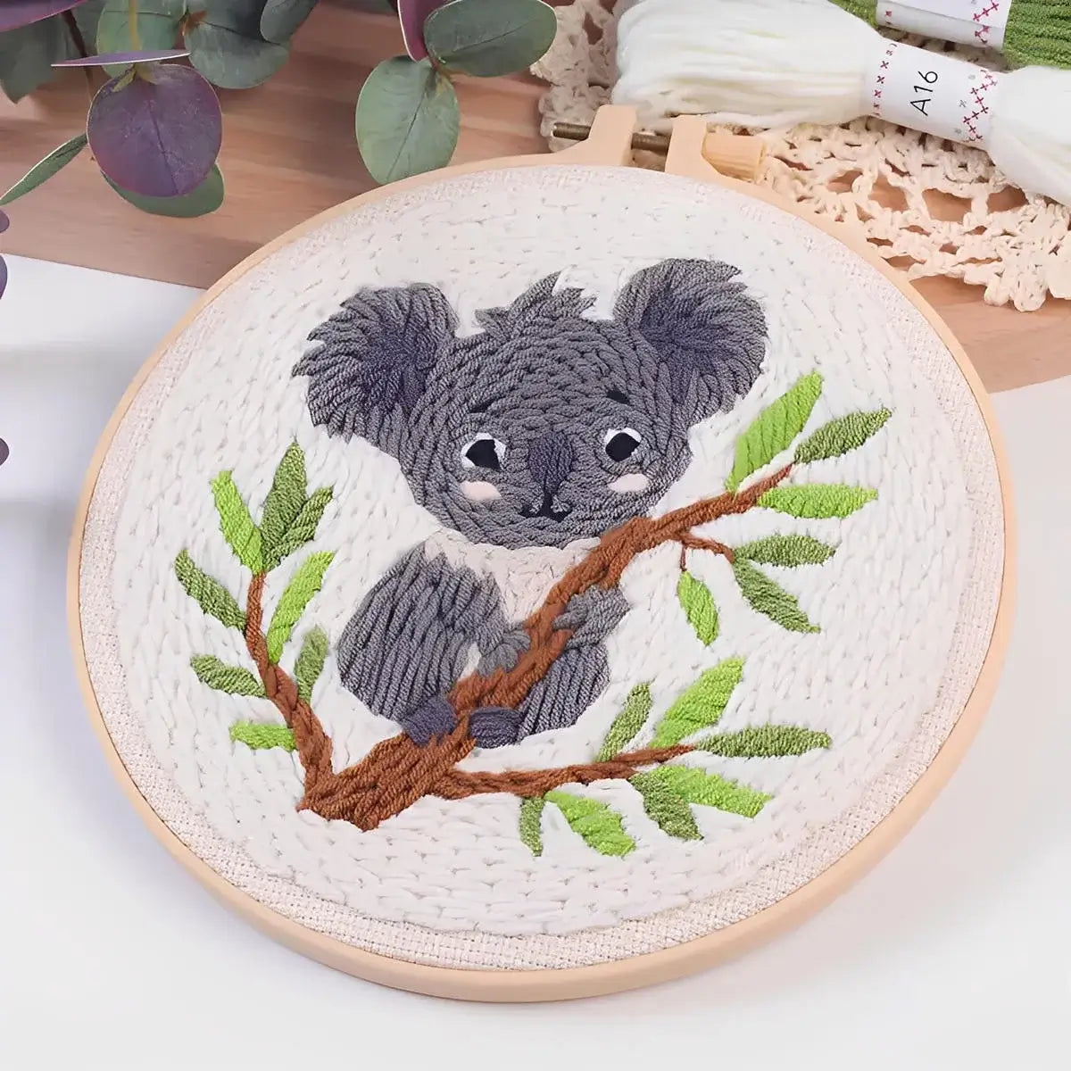CraftHoop Cozy Koalas Punch Needle Kit featuring a detailed koala design on a pre-printed fabric.