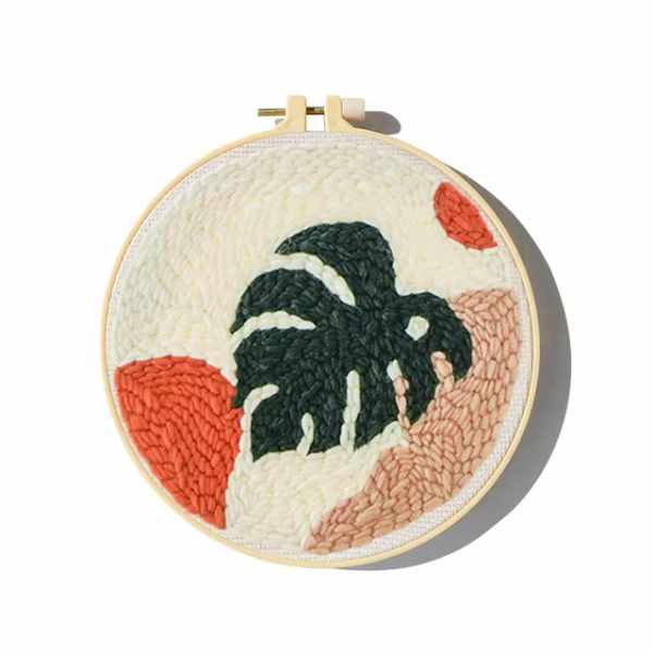 CraftHoop punch needle embroidery kit with a tropical leaf design, showcasing the finished product with detailed texture.