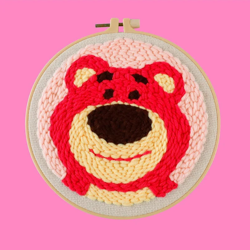 CraftHoop happy red character embroidery on pink fabric - Cute and playful DIY sewing project