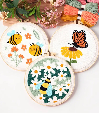 CraftHoop Buzz & Bloom Punch Needle Kit featuring bees, a butterfly, and daisies in colorful embroidery.