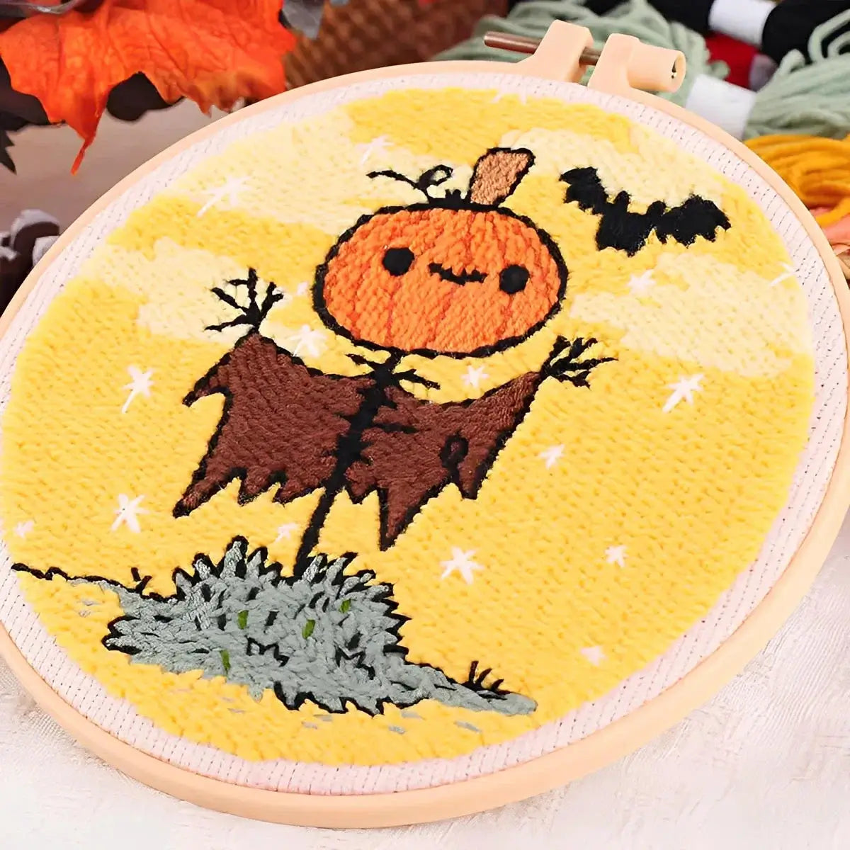 CraftHoop Pumpkin Halloween Punch Needle Kit featuring a cheerful pumpkin scarecrow with bats.