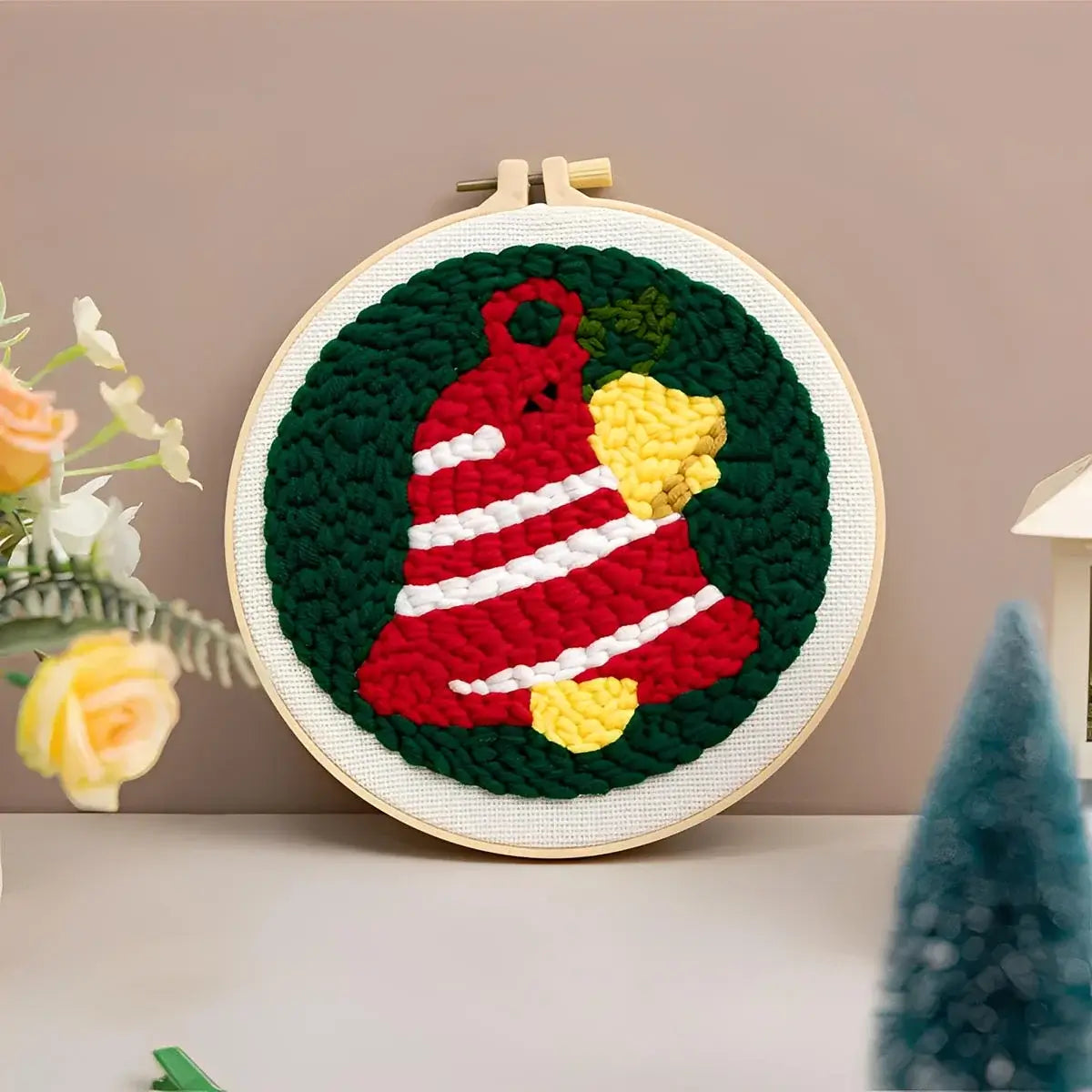 CraftHoop Christmas Cheer Punch Needle Kit featuring a festive red and green bell design for holiday crafting.