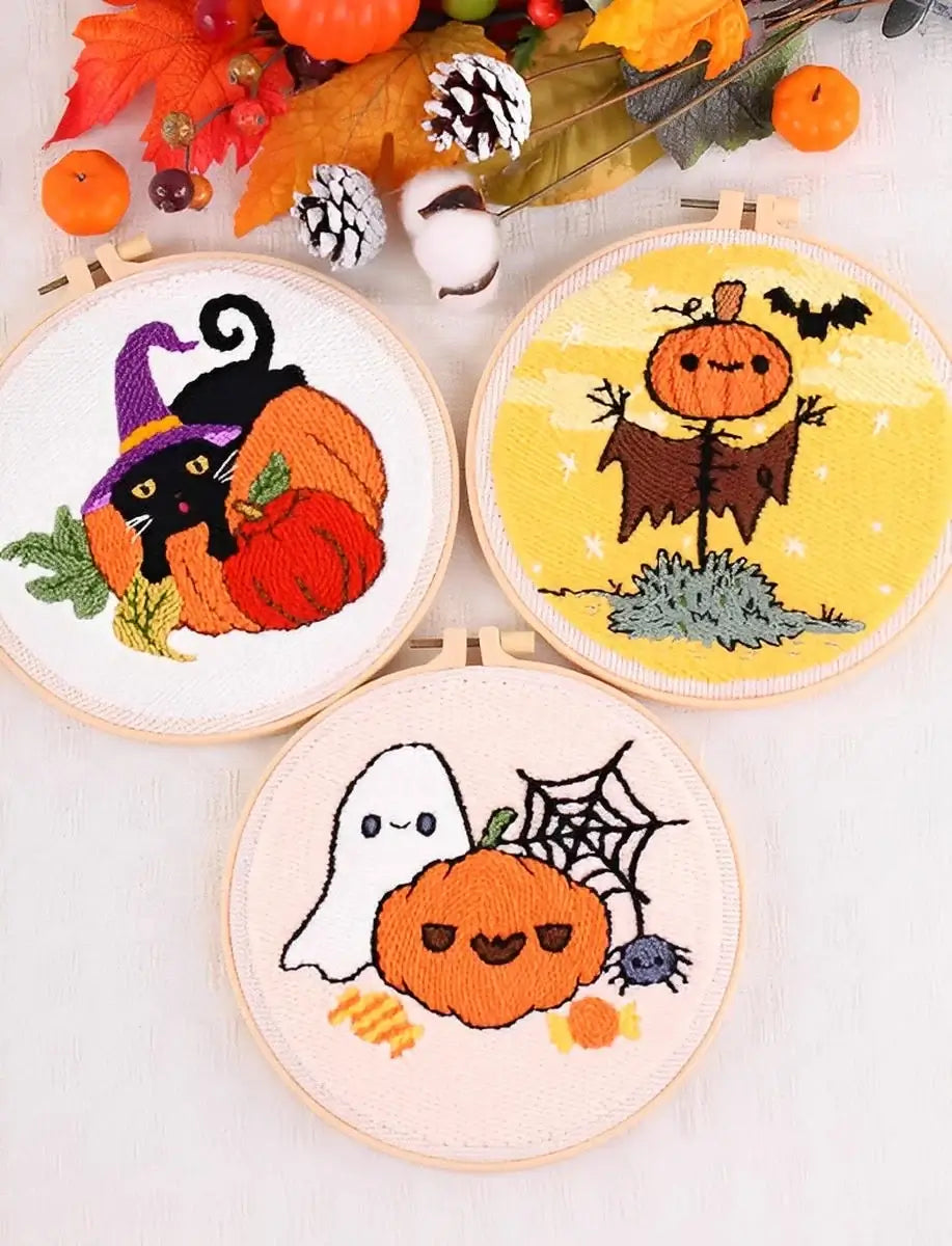 CraftHoop Pumpkin Halloween Punch Needle Kit featuring a black cat, pumpkin, ghost, and scarecrow in embroidery hoops.
