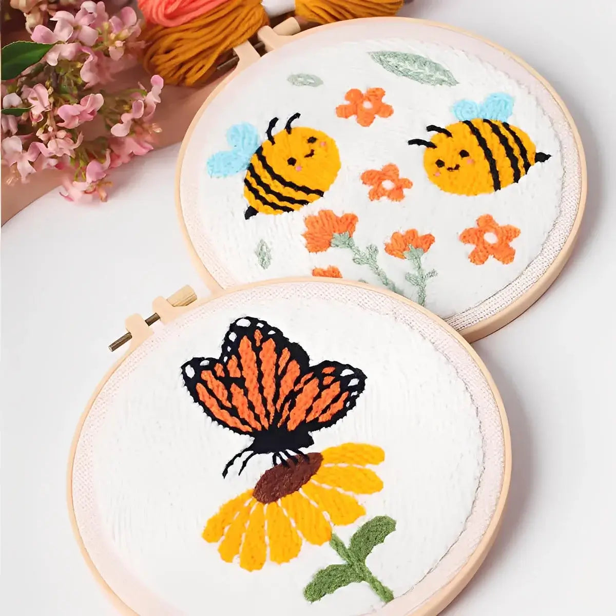 CraftHoop Buzz & Bloom Punch Needle Kit featuring embroidered bees and butterfly on floral backgrounds.