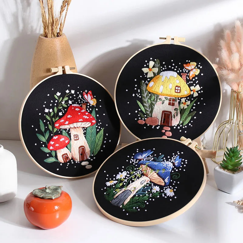 Collection of mushroom-themed embroidery kits from CraftHoop, featuring various designs on black fabric, displayed together in a decorative arrangement