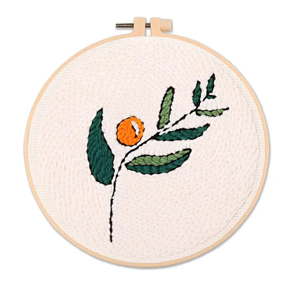 CraftHoop Botanical Muse Punch Needle Kit showcasing vibrant greenery and citrus design in an embroidery hoop.