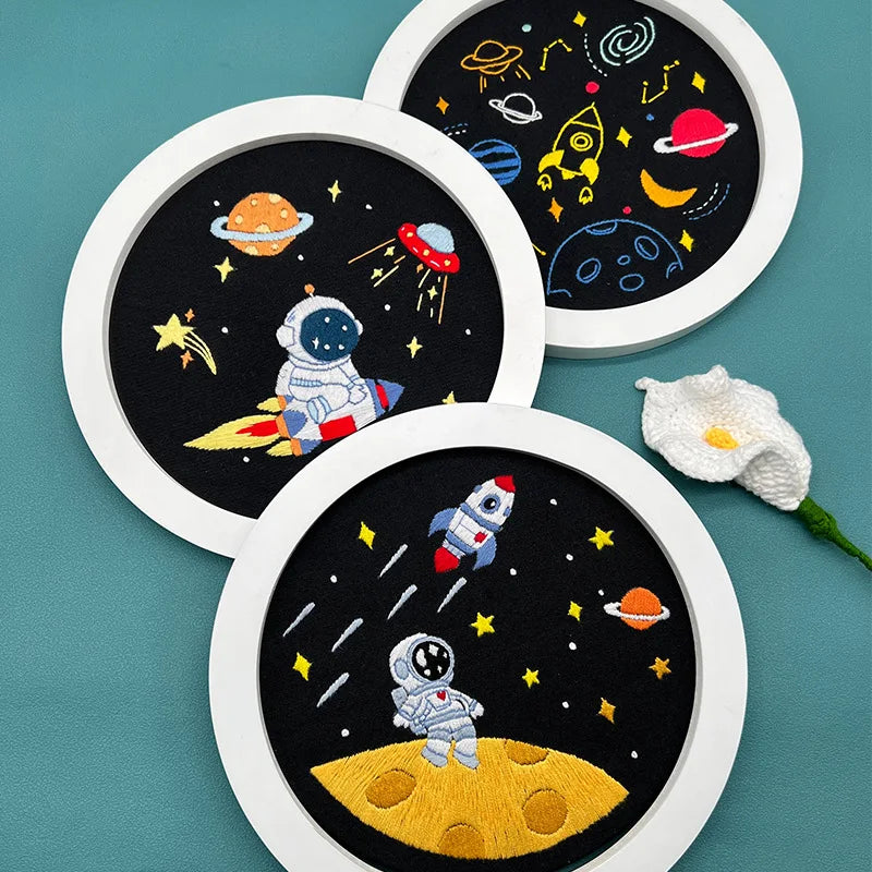 Close-up of CraftHoop Little Astronaut Embroidery Kit showing detailed embroidery patterns of a space theme.