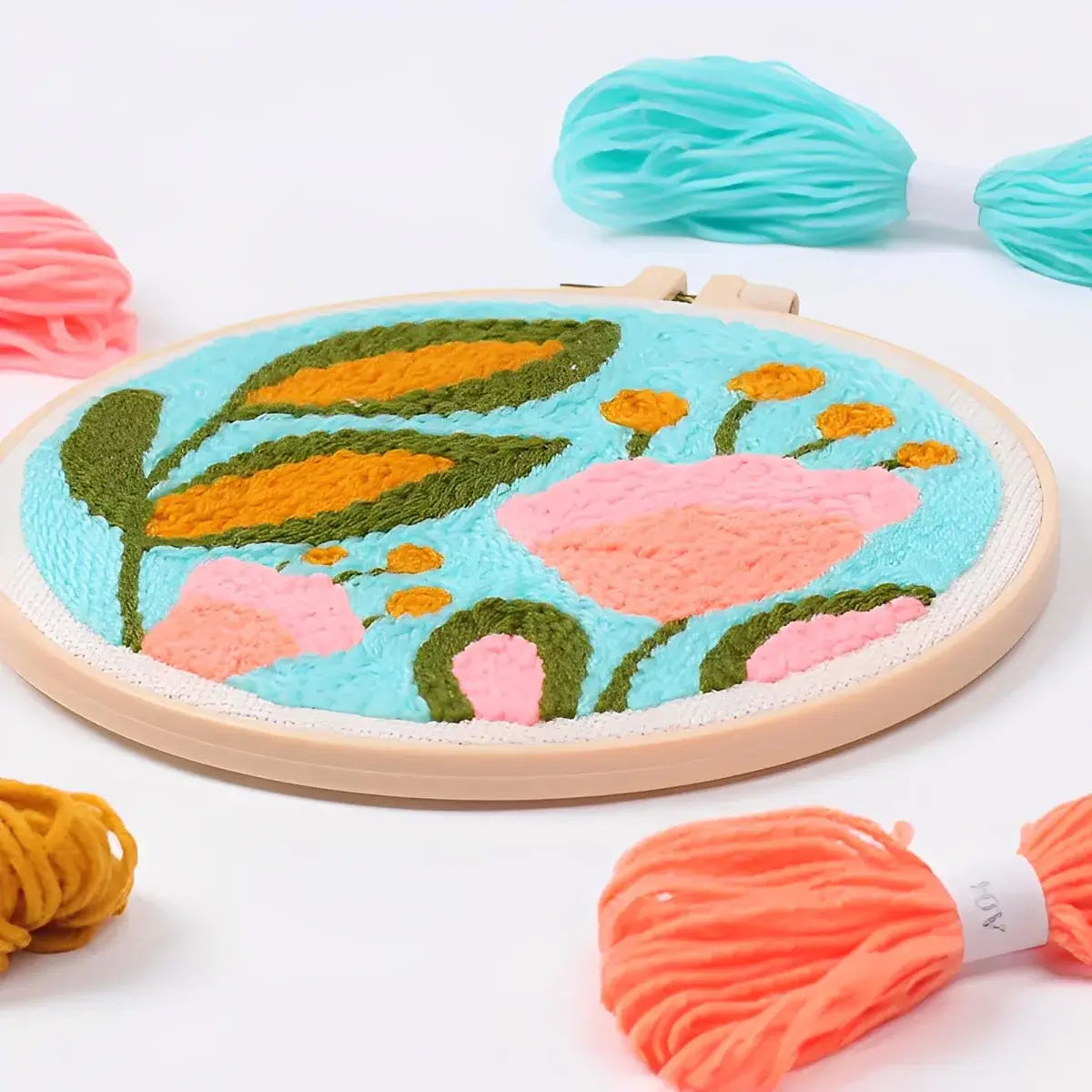 CraftHoop Garden Glow Punch Needle Kit featuring colorful floral design on a fabric hoop with vibrant yarns.