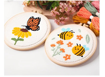 CraftHoop Buzz & Bloom Punch Needle Kit featuring a butterfly and playful bees on embroidered hoops.