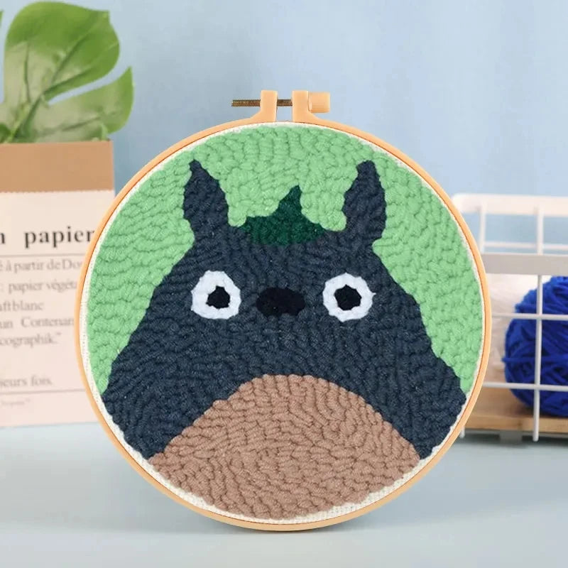 CraftHoop green cartoon character embroidery on light fabric - Fun and playful DIY sewing project