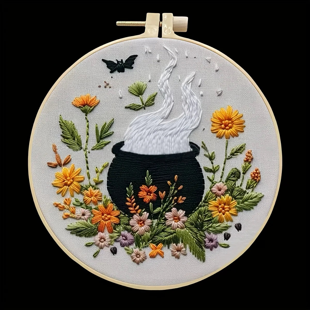 CraftHoop Crow Magic Halloween Embroidery Kit featuring a colorful floral design with a steaming cauldron.