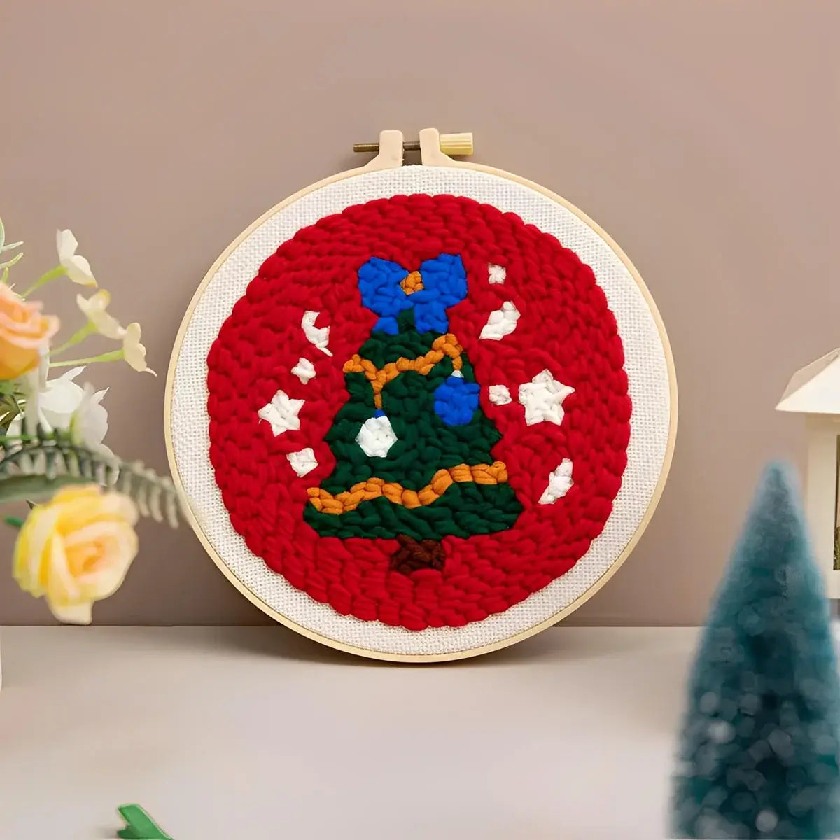 CraftHoop Christmas Cheer Punch Needle Kit featuring a festive red background with a Christmas tree design.