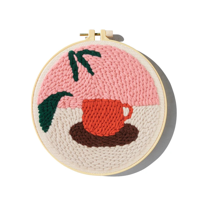 CraftHoop punch needle embroidery kit with a completed leaf and abstract design, showcasing the texture and colors.