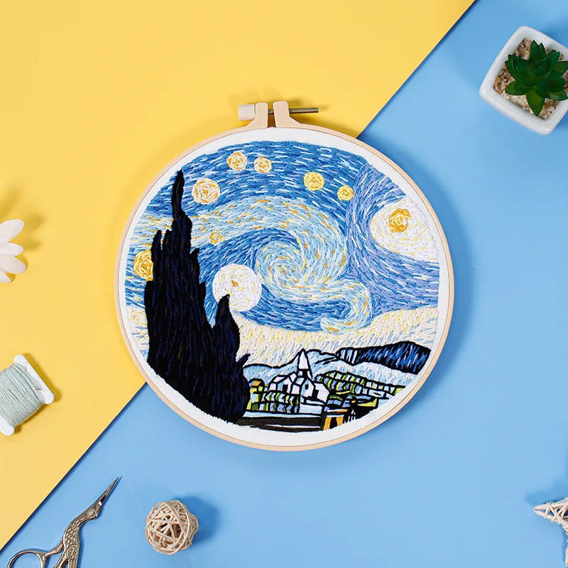 Two starry night embroidery kits from CraftHoop, featuring Van Gogh-inspired designs, displayed on a pink background with embroidery materials