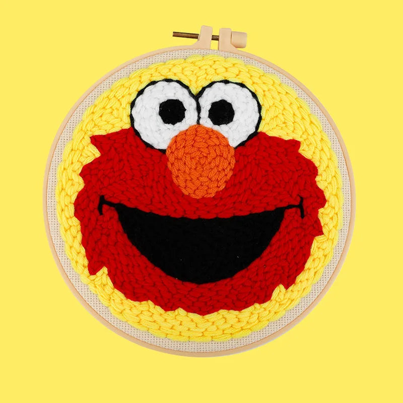 CraftHoop red furry character embroidery on yellow fabric - Colorful and iconic DIY needlework project