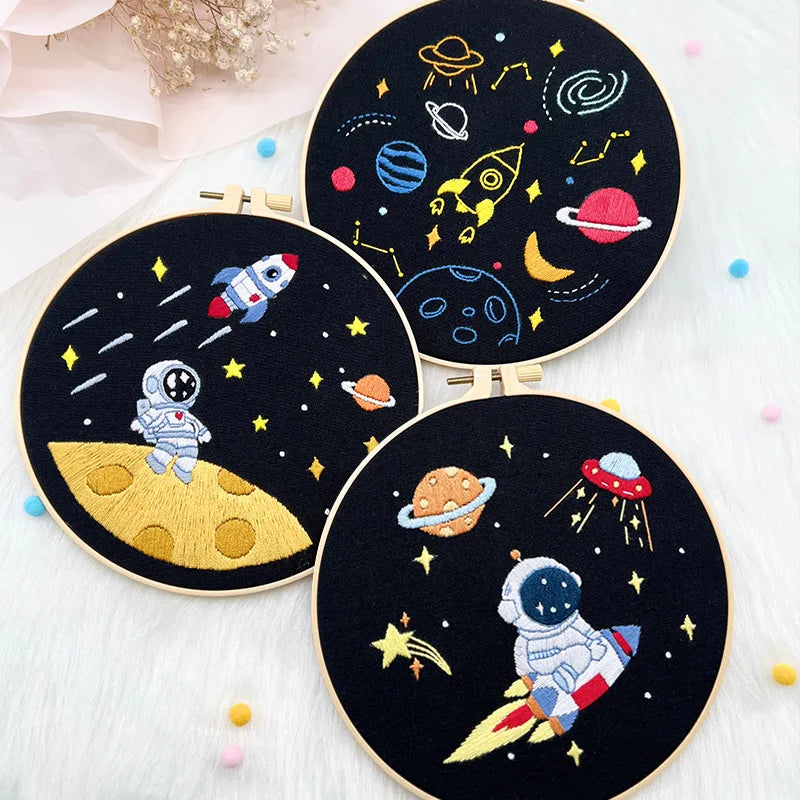 CraftHoop Little Astronaut Embroidery Kit with moon and stars design in various stages of completion.