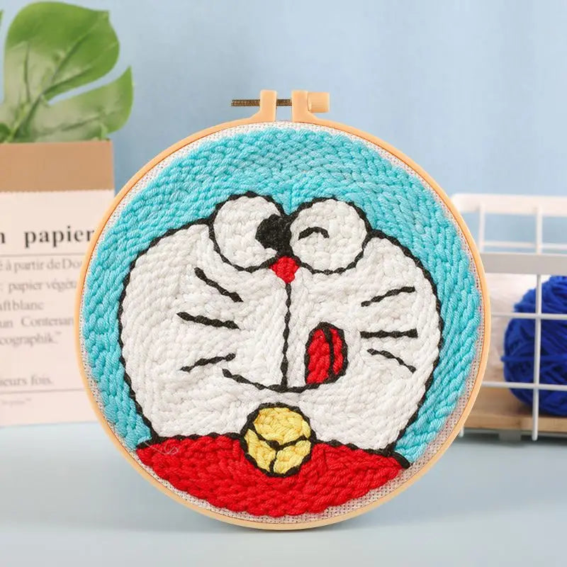 CraftHoop blue cartoon character embroidery on light fabric - Fun and nostalgic needlework project