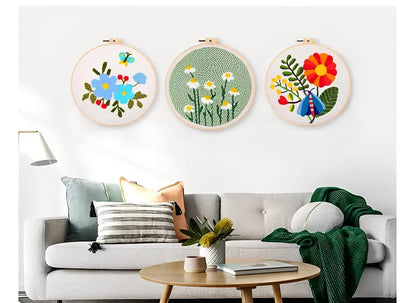 CraftHoop Garden Glow Punch Needle Kit displayed as vibrant wall art on a stylish couch.