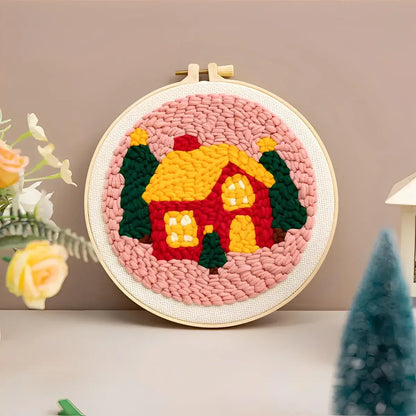 CraftHoop Christmas Cheer Punch Needle Kit finished project featuring a colorful house with trees, perfect for holiday decor.