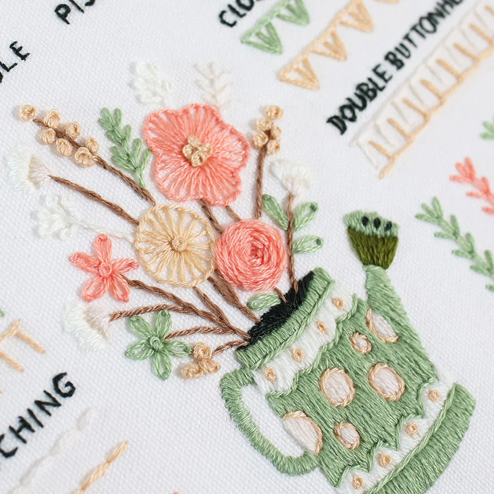 CraftHoop Beginner’s Embroidery Starter Kit floral pattern in green watering can with colorful flowers.