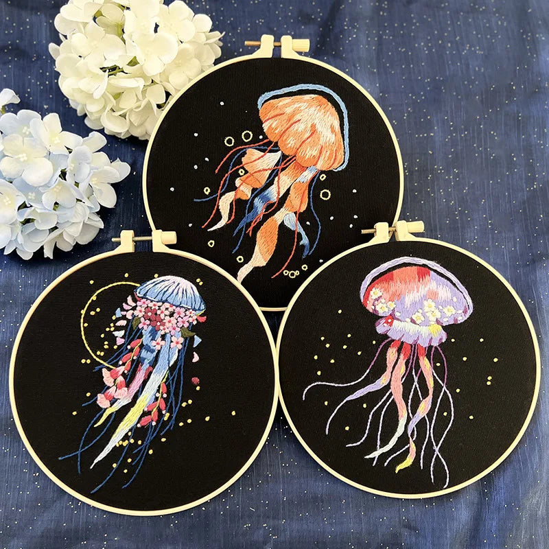 Collection of jellyfish-themed embroidery kits from CraftHoop, featuring various vibrant designs on black fabric, displayed together in a decorative arrangement