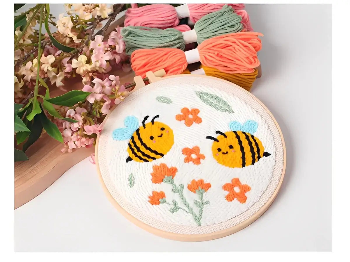 CraftHoop Buzz & Bloom Punch Needle Kit featuring playful bees and flowers in a colorful design.