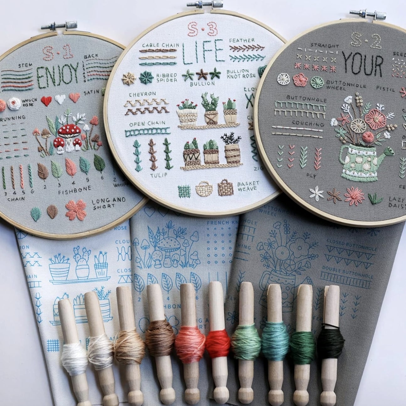 CraftHoop embroidery kit featuring three designs with essential stitch patterns, colored threads, and pre-printed fabric, ideal for beginners