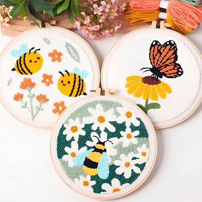 CraftHoop Buzz & Bloom Punch Needle Kit featuring playful bees, butterfly and blooming flowers in vibrant colors.