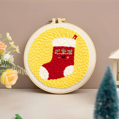 CraftHoop Christmas Cheer Punch Needle Kit featuring a festive red stocking design against a yellow background.