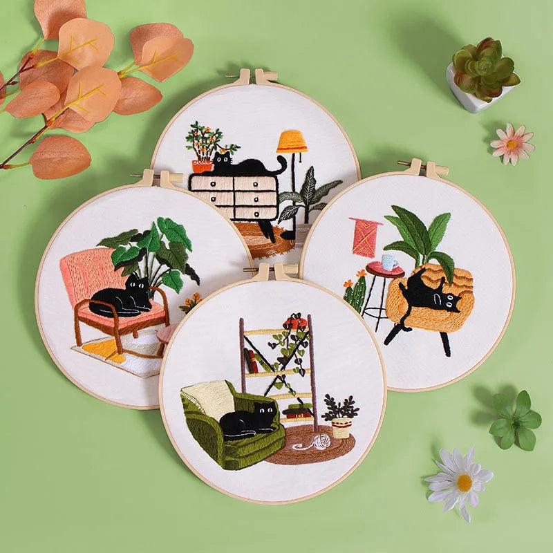 Close-up of various CraftHoop Cat Lover's Home Kit embroidery hoops featuring cats and plants.