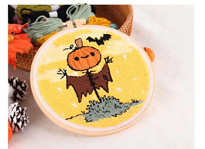 CraftHoop Pumpkin Halloween Punch Needle Kit showcasing a playful scarecrow design with a pumpkin in an embroidery hoop.