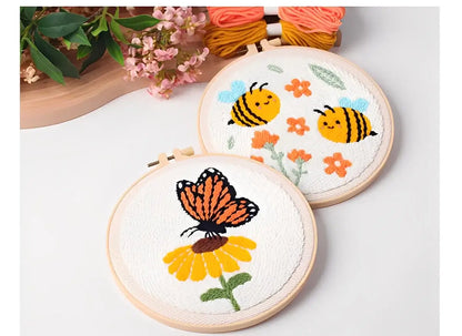 CraftHoop Buzz & Bloom Punch Needle Kit showcasing bees and a butterfly on embroidered hoops.
