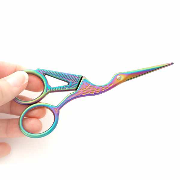 Rainbow-colored stork embroidery scissors, displayed on a white background, highlighting the sharp pointed blades and sturdy stainless steel construction